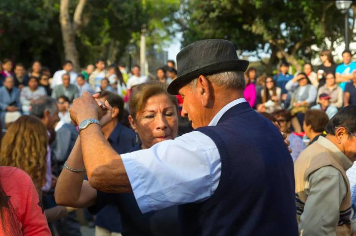 Participants enjoying a public Salsa dancing event in Parque Kennedy, located in the Miraflores district.