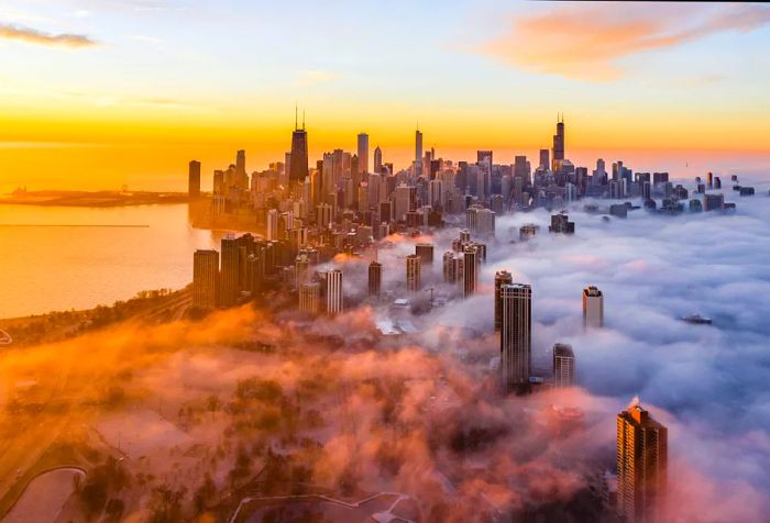 The skyline of this modern city is a breathtaking sight, showcasing towering skyscrapers partially hidden in a veil of clouds, set against a stunning twilight backdrop that creates a captivating urban scene.