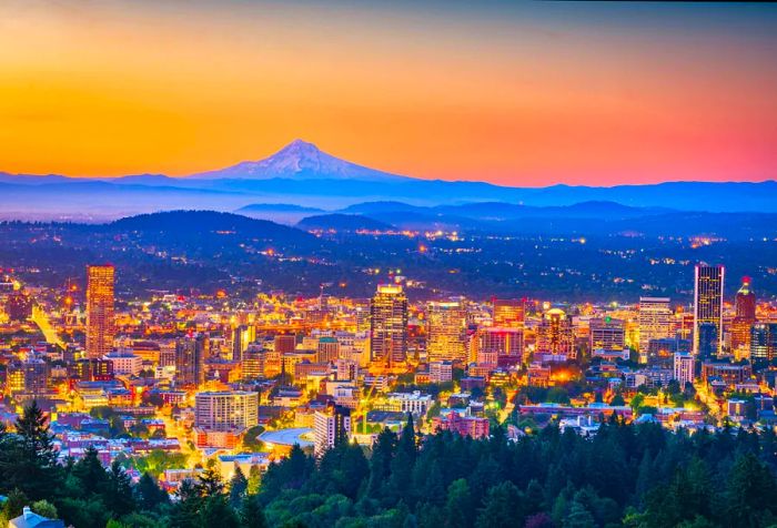 A stunning city skyline set against misty, forested mountains under vibrant orange skies.