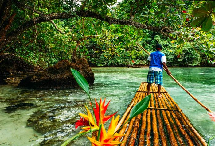 A local man navigates a bamboo raft across the serene forest lagoon.