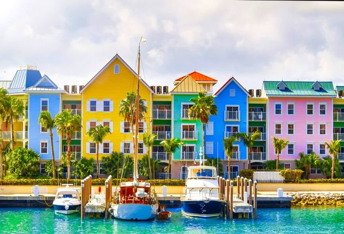 Vibrant, contemporary townhouses lining the coast with yachts anchored in the turquoise waters.