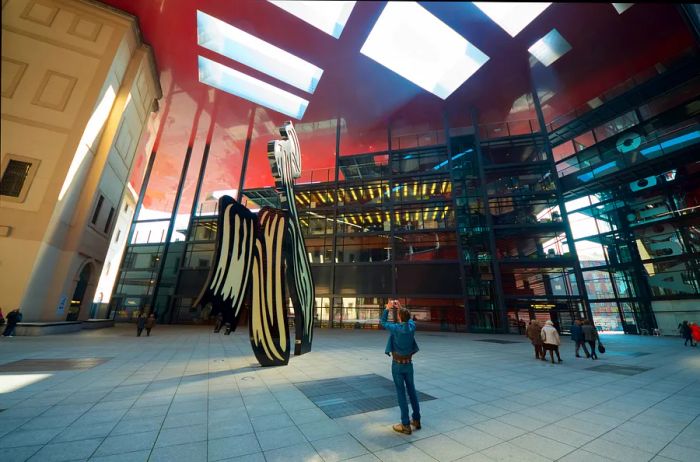 Visitors explore the Centro de Arte Reina Sofía art museum in Madrid