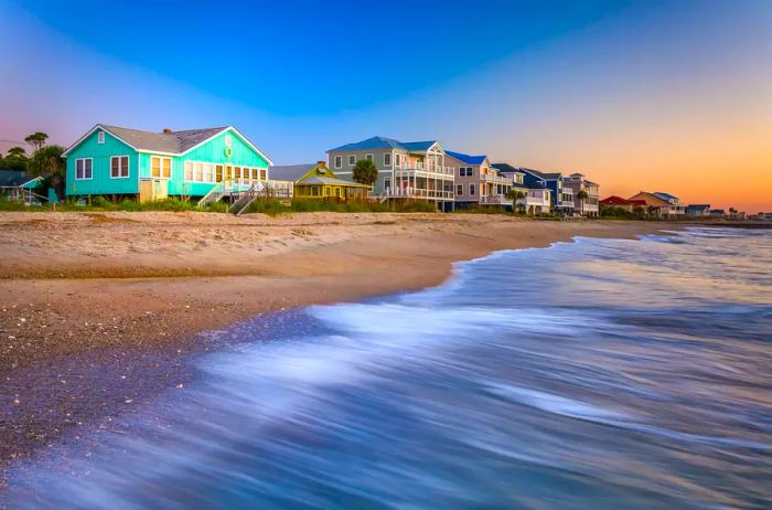 Atlantic Ocean waves and sunrise views of beachfront homes at Edisto Beach, South Carolina