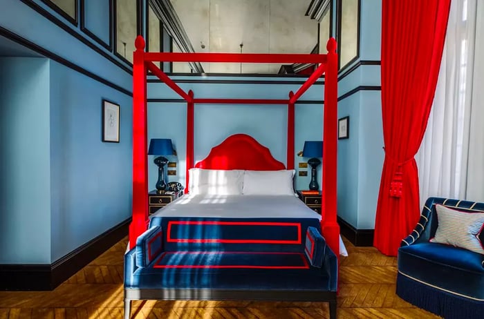 Interior of a hotel guest room featuring red and blue decor