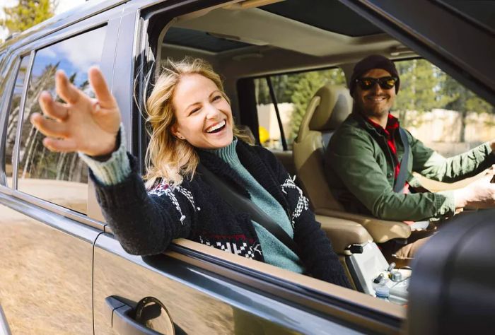 theme_car_couple_woman_happy_gettyimages-1149890083_universal_within-usage-period_59488-1