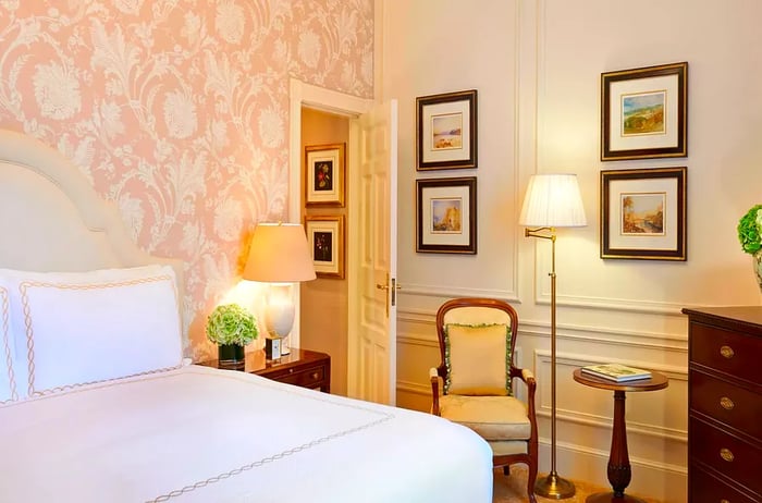 A soft pink guest room at The Savoy London hotel