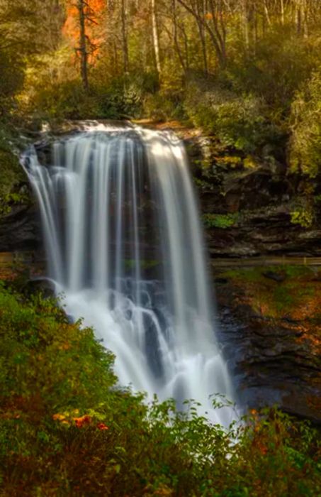 A picturesque autumn view of Dry Creek Falls in Highlands, North Carolina, along US Highway 64