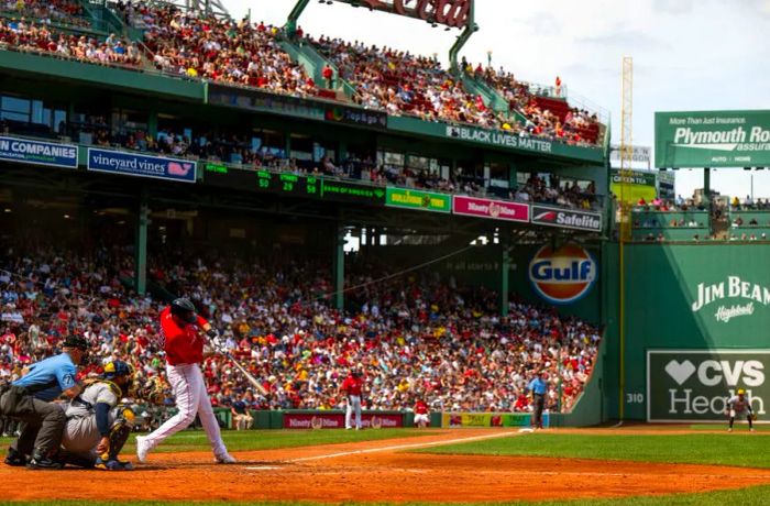 J.D. Martinez #28 of the Boston Red Sox hits a double during the fourth inning against the Milwaukee Brewers on July 31, 2022, at Fenway Park in Boston, Massachusetts.