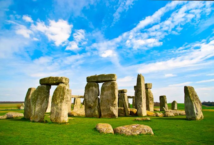 Famous worldwide, the prehistoric site of Stonehenge in England features massive standing stones that are connected by horizontal stones above.