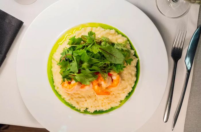 Shrimp risotto garnished with fresh greens.