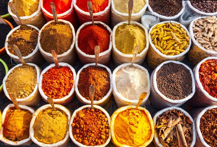 A vibrant display of colorful dried herbs and spices in a retail setting.