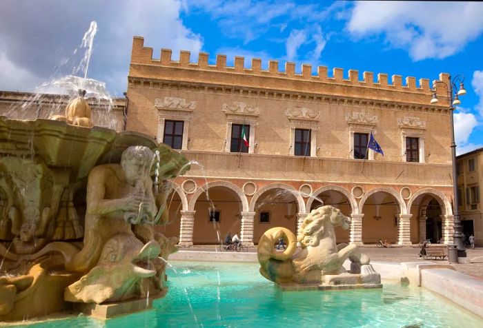 A fountain and Renaissance palace in Pesaro, Marche, Italy.