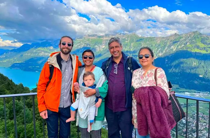 A family group photo taken atop a mountain in Switzerland