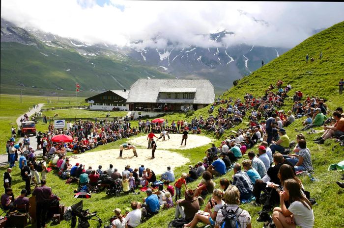 Spectators observe Swiss wrestling matches (Schwingen) on the Engstligenalp near Adelboden, Switzerland