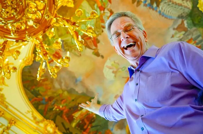 Baroque Art: Rick Steves beneath the stunning ceiling of the Great Gallery at SchÃ¶nbrunn Palace in Vienna, Austria.