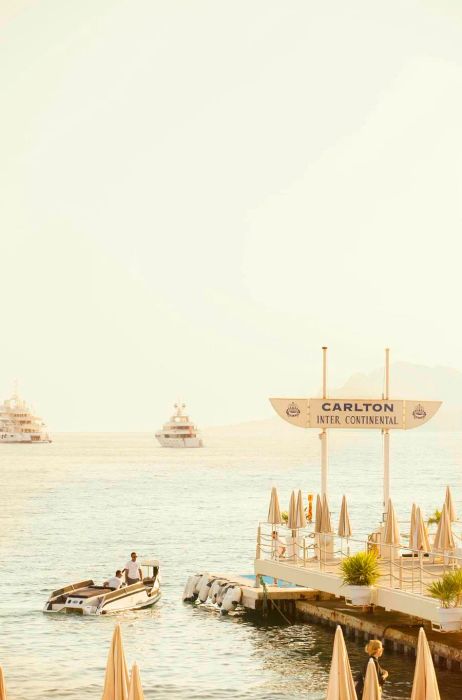 A smaller vessel departs from the pier at the edge of the Carlton Beach Club © Philip Lee Harvey/Dinogo Planet