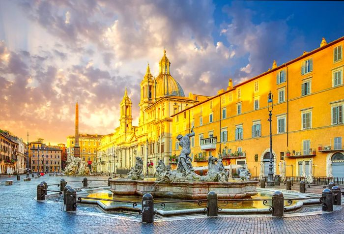 A vibrant town square flanked by buildings featuring two towers, with the stunning Fontana del Nettuno at its center.