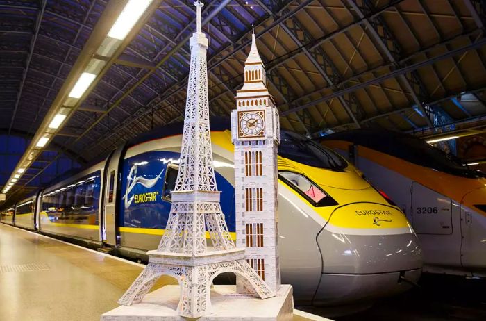 Famous landmarks of London and Paris crafted from recycled train tickets stand outside a Eurostar train in London.