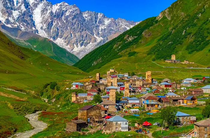 A panoramic view of the medieval towers of Ushguli set against the backdrop of Mount Shkhara in Svaneti, Georgia