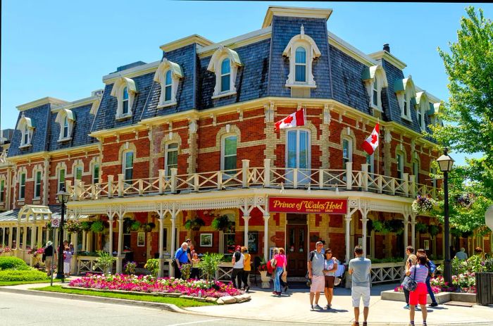 Visitors capture memories in front of the iconic red-brick Prince of Wales Hotel in Niagara-on-the-Lake, Ontario, Canada