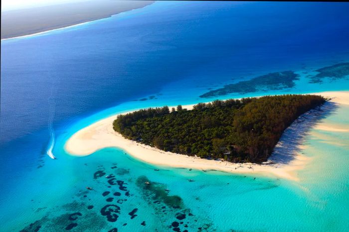 Aerial view of the fin-shaped coastline of andBeyond Mnemba Island