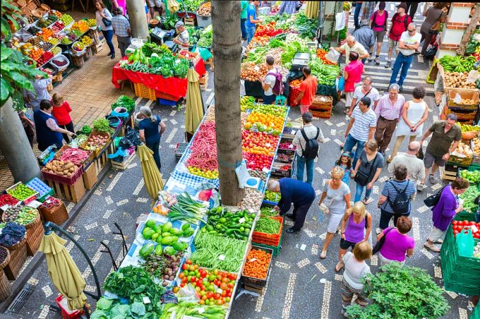 Funchal, Portugal, - Aug 01: Tourists exploring the local vegetable market