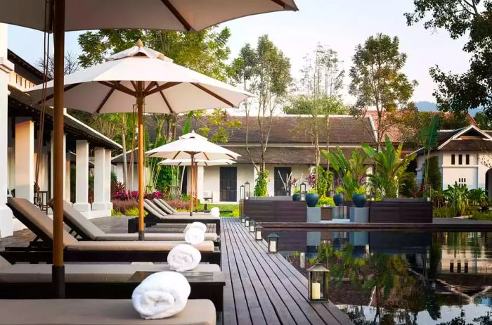 Lounge chairs beside the pool at Sofitel Luang Prabang