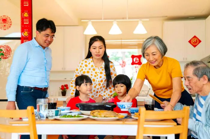 A multi-generational family in Taipei preparing to share their Lunar New Year meal together.