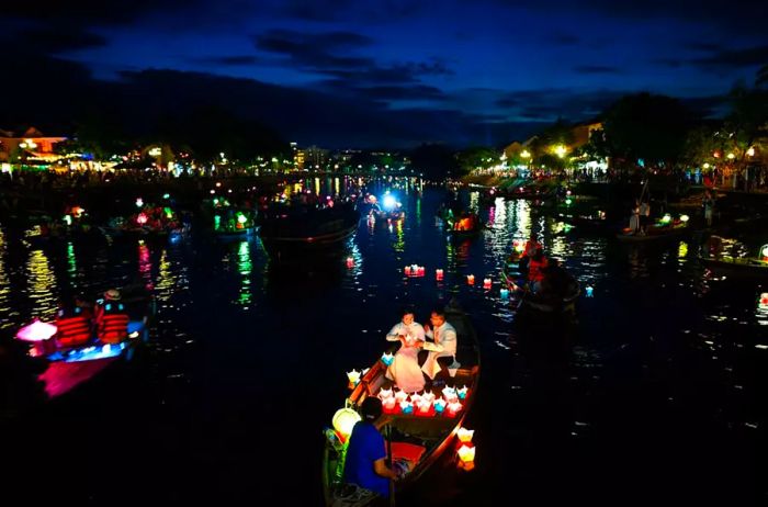 As dusk falls, people enjoy boat rides on the Thu Bon River to release paper lanterns, a gesture for good luck during the Mid-Autumn Festival.