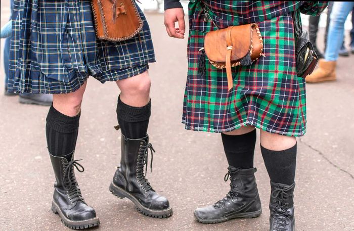 Two bagpipers dressed in traditional Scottish kilts