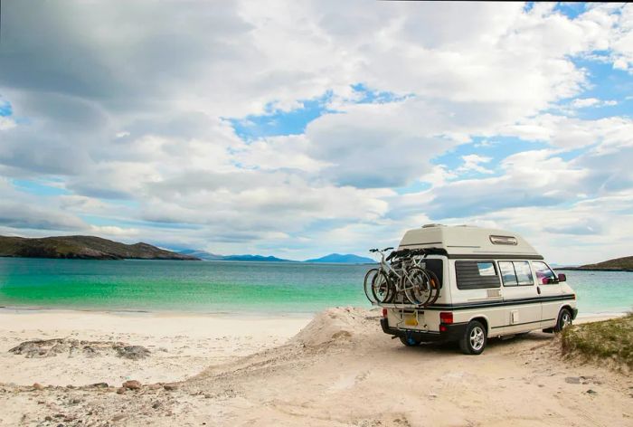 A camper van is parked on a beach in the Isle of Lewis, Outer Hebrides, Scotland, UK.