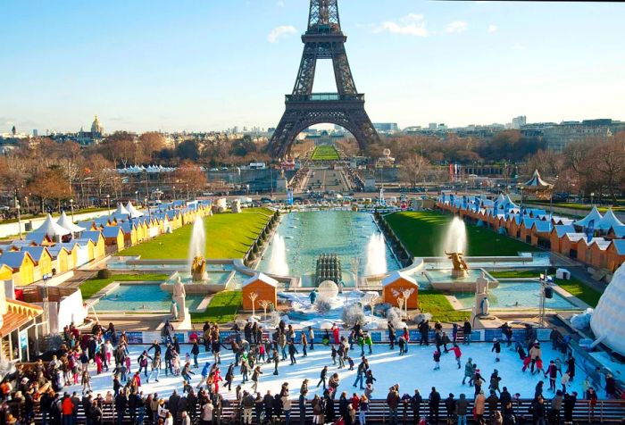 Ice skating rink during the holiday season with the Eiffel Tower in the backdrop, Paris, France.