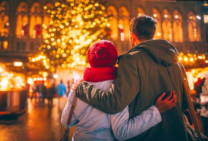 A lovely couple pausing to take in the festive street decorations.