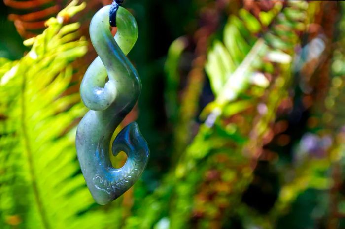 A greenstone pendant featuring a loop, twist, and hook at the end.