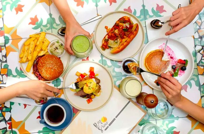 A view of Western brunch options like pancakes and burgers at a Malaysian restaurant.