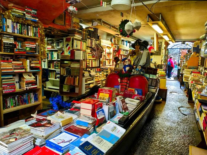 Books piled high in a gondola at the Acqua Alta bookstore, Venice, Italy