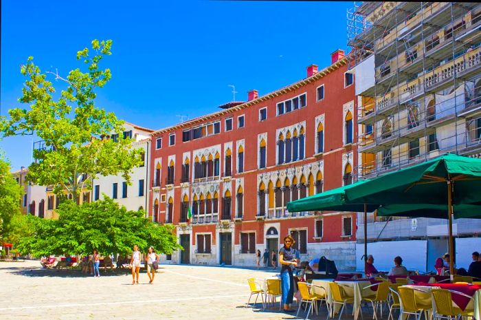 Bright sunshine and outdoor seating in Campo San Polo square, Venice