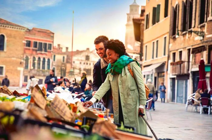 A couple enjoying a shopping spree at an outdoor fruit market in Venice