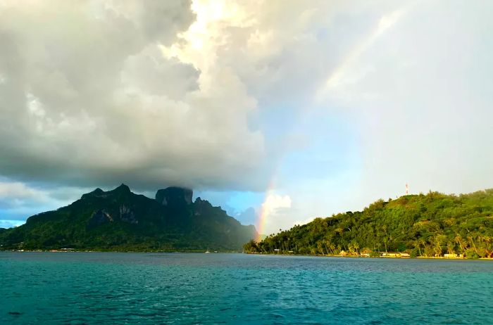 A rainbow split by rain over Tahiti