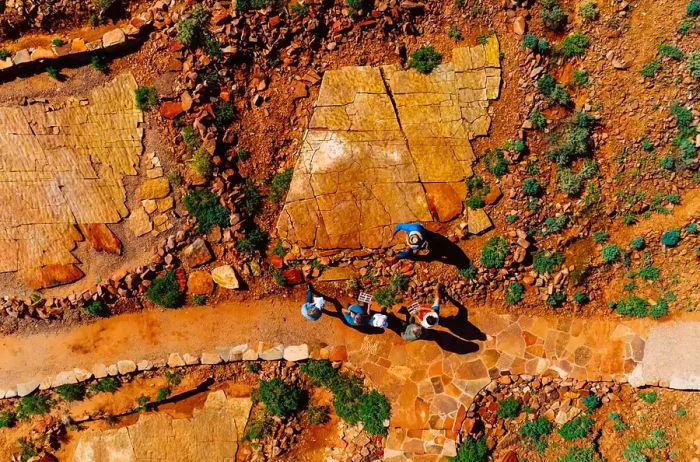 Aerial shot of a group of individuals searching for fossils in Nilpe­na Ediacara National Park