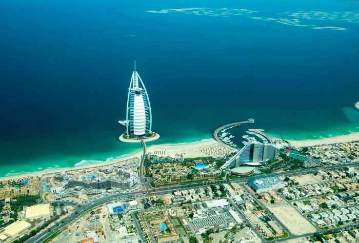 The stunning Burj Al Arab situated in the Jumeirah district, alongside its beautiful beach.