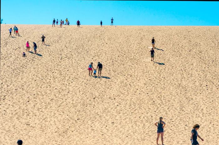 Visitors traverse the Sleeping Bear Dunes to reach Lake Michigan