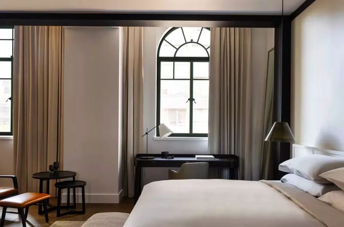 Sleeping and workspace in the Deluxe suite at Capella Sydney, a luxury hotel in Australia