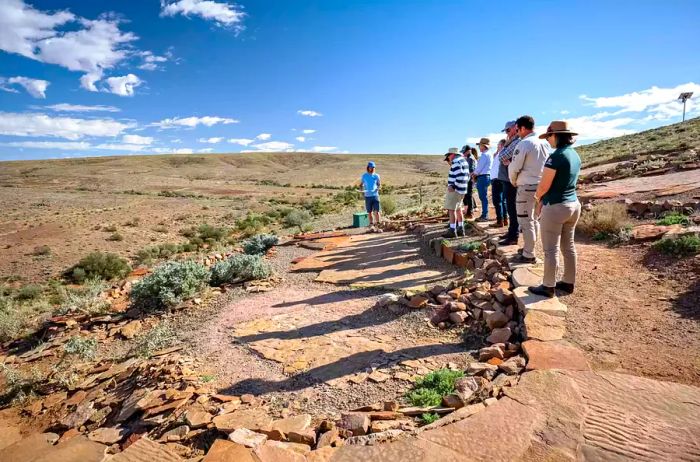 A group of visitors examines fossils found in the earth of Australia's Flinders Range