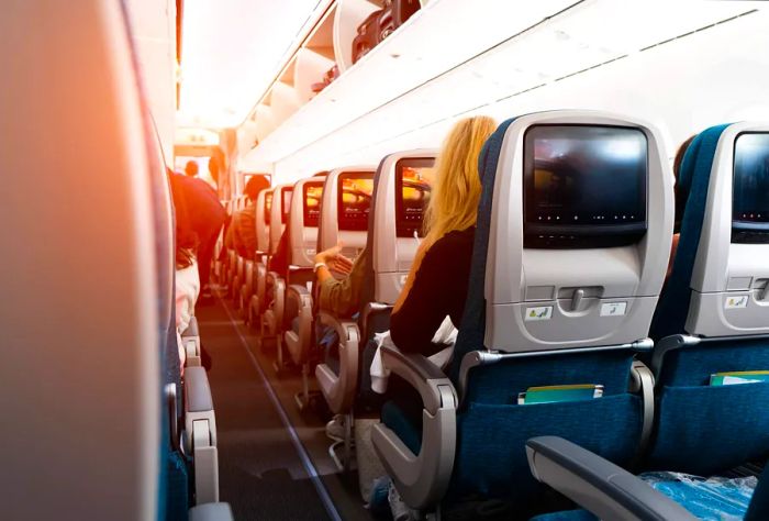 Passengers seated in the back rows of an aircraft