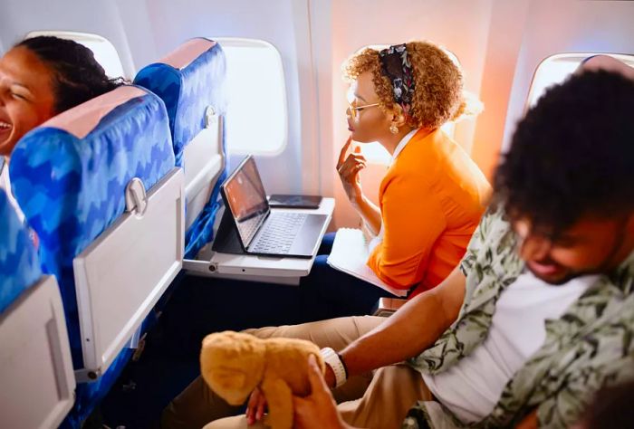 Passengers enjoying a movie on a flight