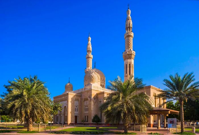 The stunning Jumeirah Mosque, framed by two minarets reaching towards the azure sky.