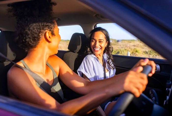 Two friends enjoying a lively car ride.