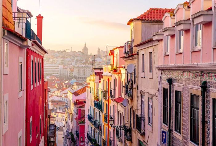 Colorful, towering buildings line a narrow street.