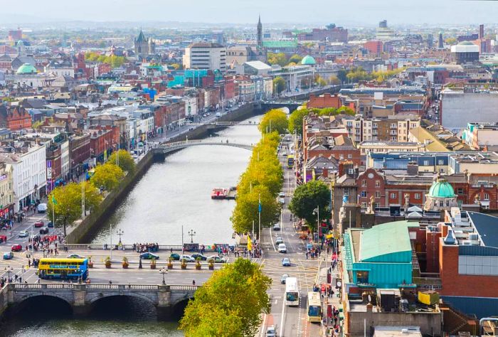 Multiple bridges span a river that divides the town from its tree-lined streets.